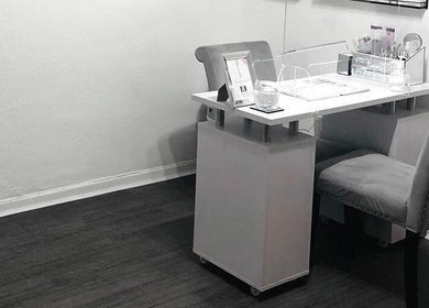 Professional nail station at Enhanced Beauty and Well-Being, Swindon, England, GB with elegant, cozy seating.