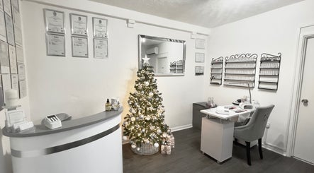Reception at Enhanced Beauty and Well-Being in Swindon, England, with a festive tree and modern decor.
