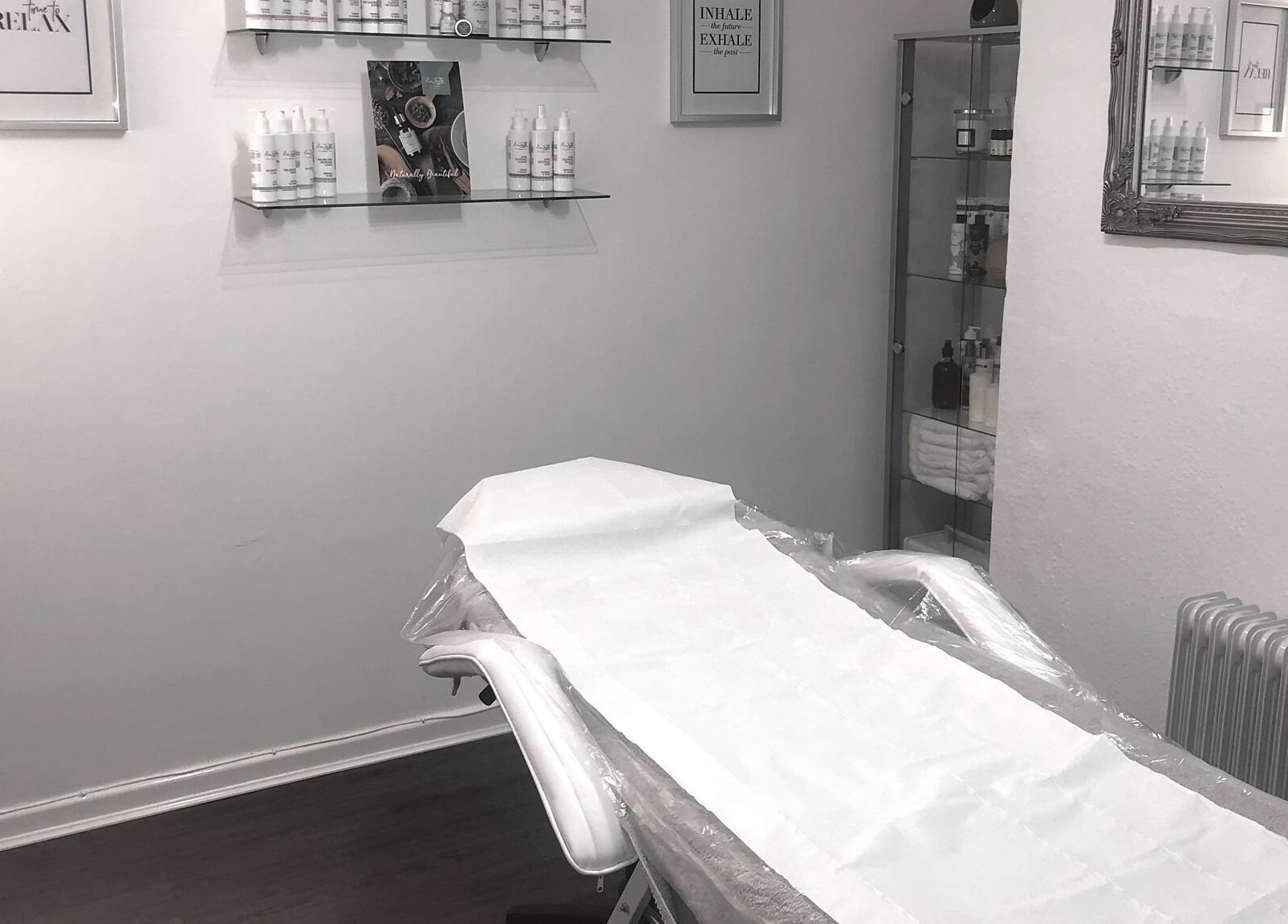 A serene treatment room at Enhanced Beauty and Well-Being in Swindon, England, GB with a neatly prepared bed.