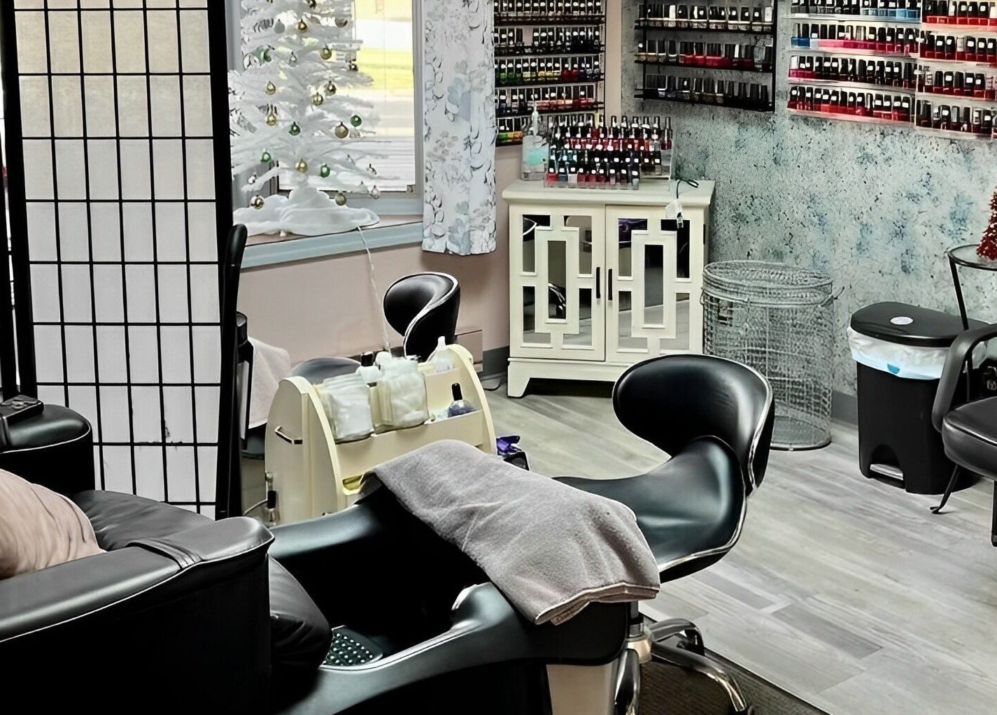 Cozy interior of manicure station at Obsessions Salon, North Tonawanda, New York, US, showcasing nail polish display.
