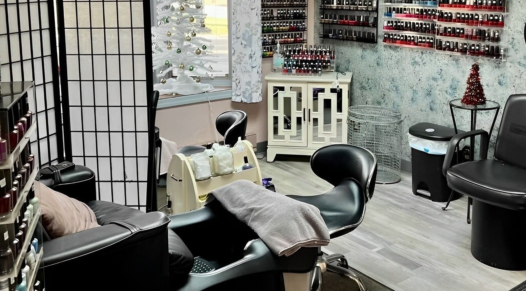 Cozy interior of manicure station at Obsessions Salon, North Tonawanda, New York, US, showcasing nail polish display.