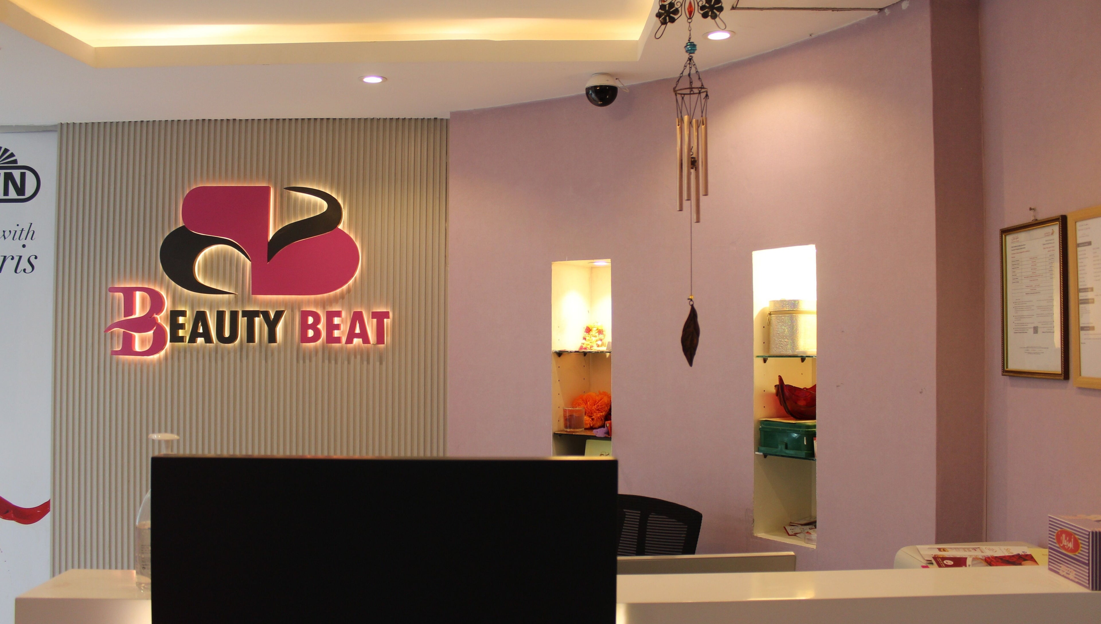 Reception area of Beauty Beat DMCC in Dubai, Dubai, AE with illuminated logo and stylish decor.