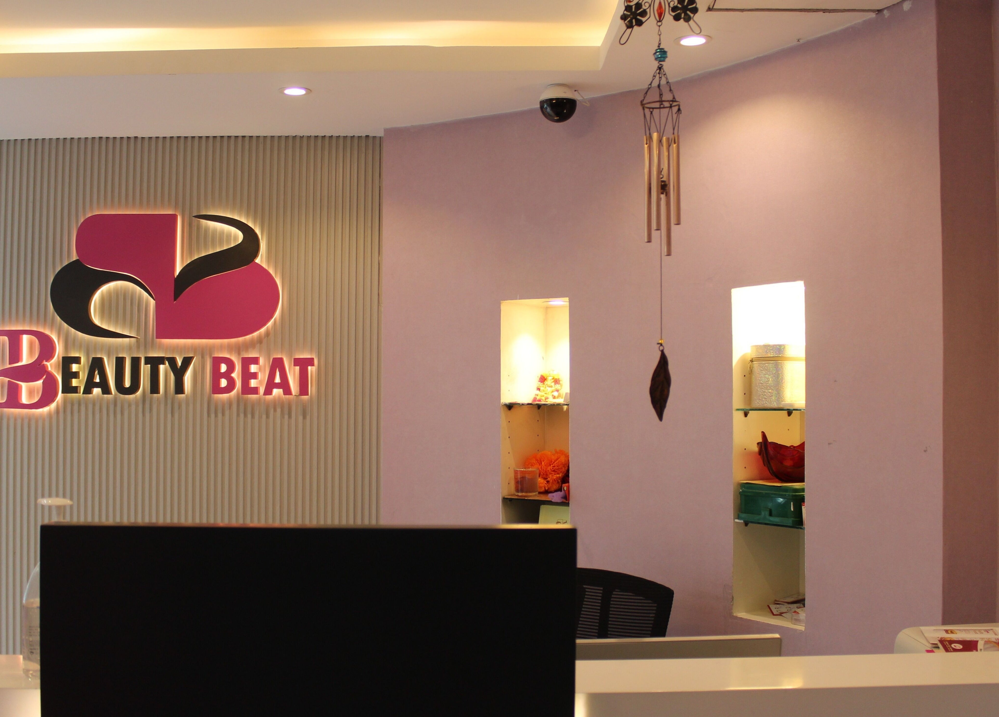 Reception area of Beauty Beat DMCC in Dubai, Dubai, AE with illuminated logo and stylish decor.