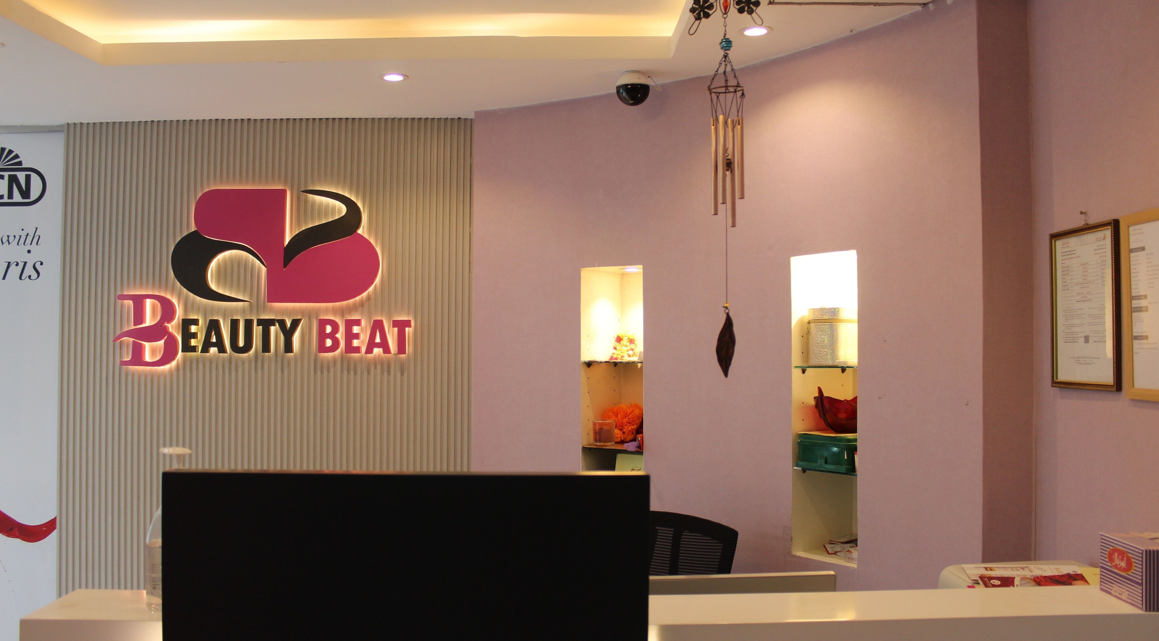 Reception area of Beauty Beat DMCC in Dubai, Dubai, AE with illuminated logo and stylish decor.