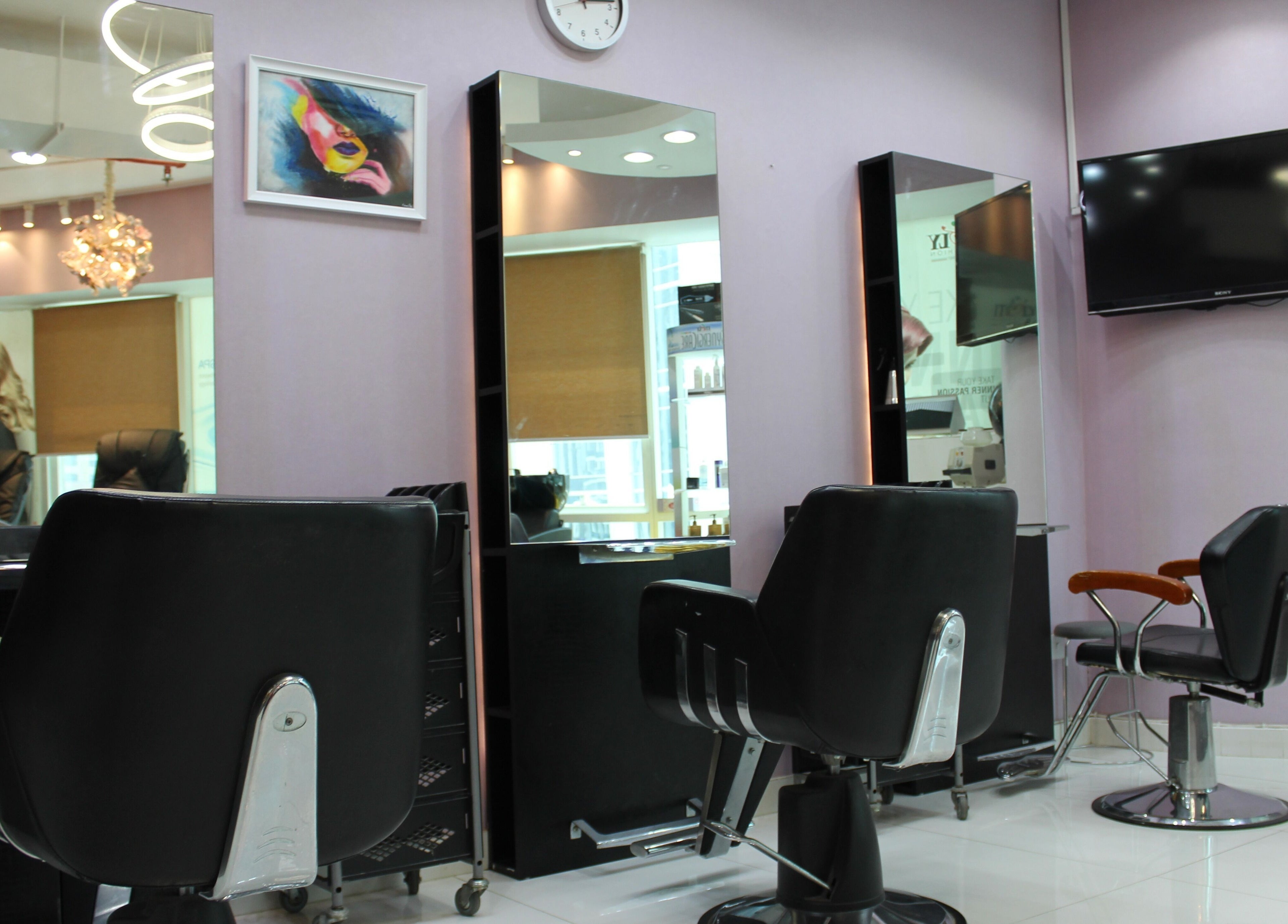 Modern salon interior at Beauty Beat DMCC, Dubai, Dubai, AE, featuring sleek chairs and mirrors.