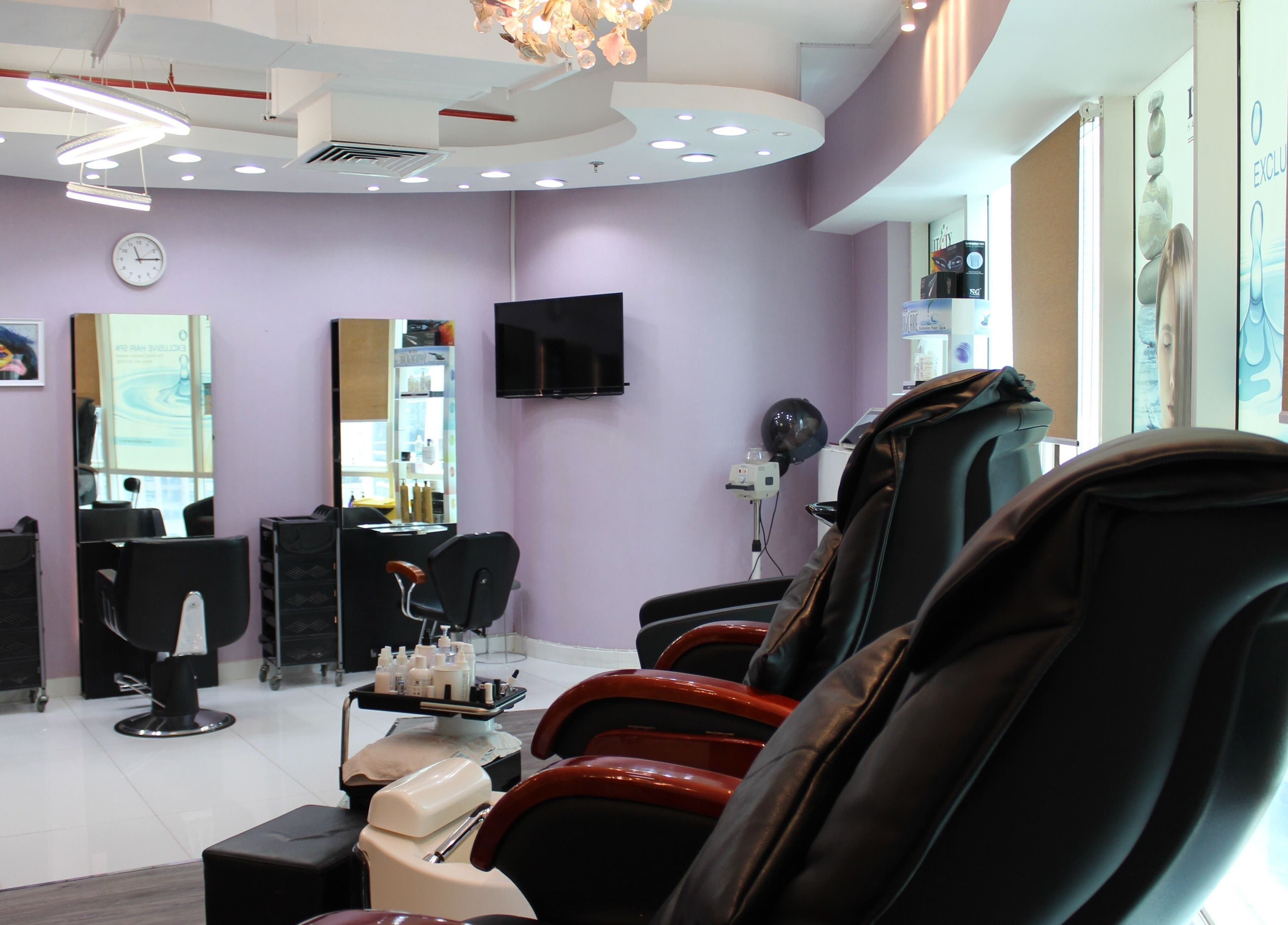 Modern salon interior at Beauty Beat DMCC, Dubai, Dubai, AE featuring luxurious massage chairs and styling stations.