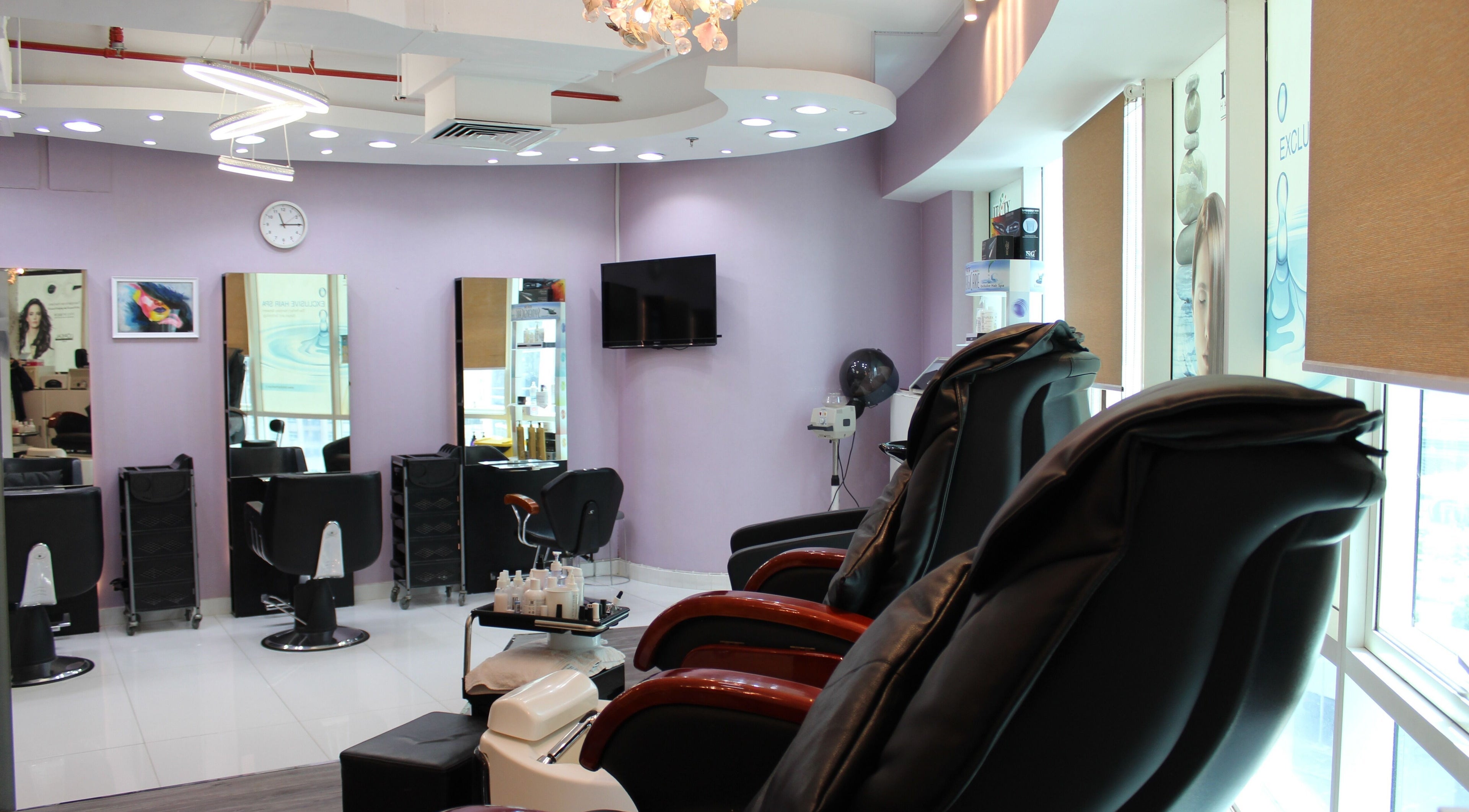 Modern salon interior at Beauty Beat DMCC, Dubai, Dubai, AE featuring luxurious massage chairs and styling stations.