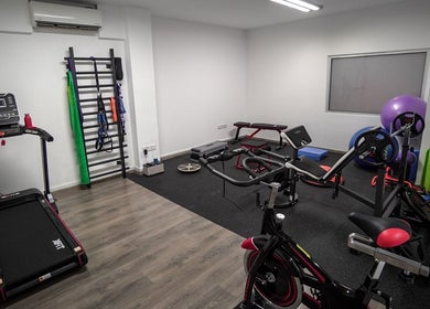 Gym equipment at Physio Vichas, Λατσιά, Λευκωσία, CY featuring treadmill, cycle, and workout gear.