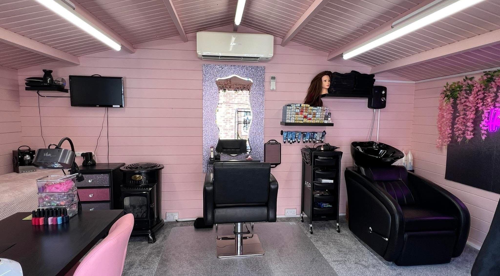 Interior of The Golden Goddess salon, Southampton, England, GB, featuring a stylish pink and black decor.