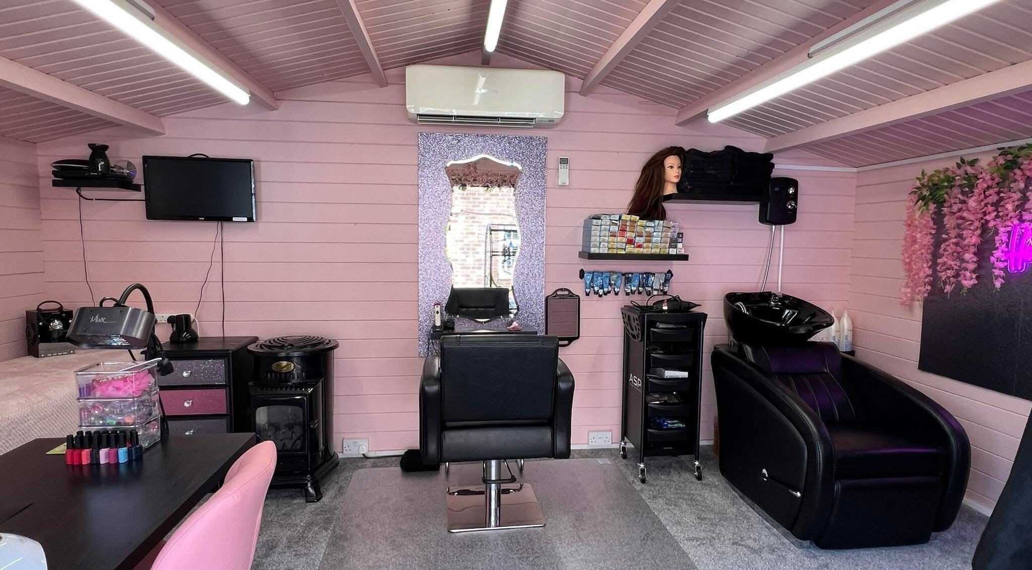Interior of The Golden Goddess salon, Southampton, England, GB, featuring a stylish pink and black decor.