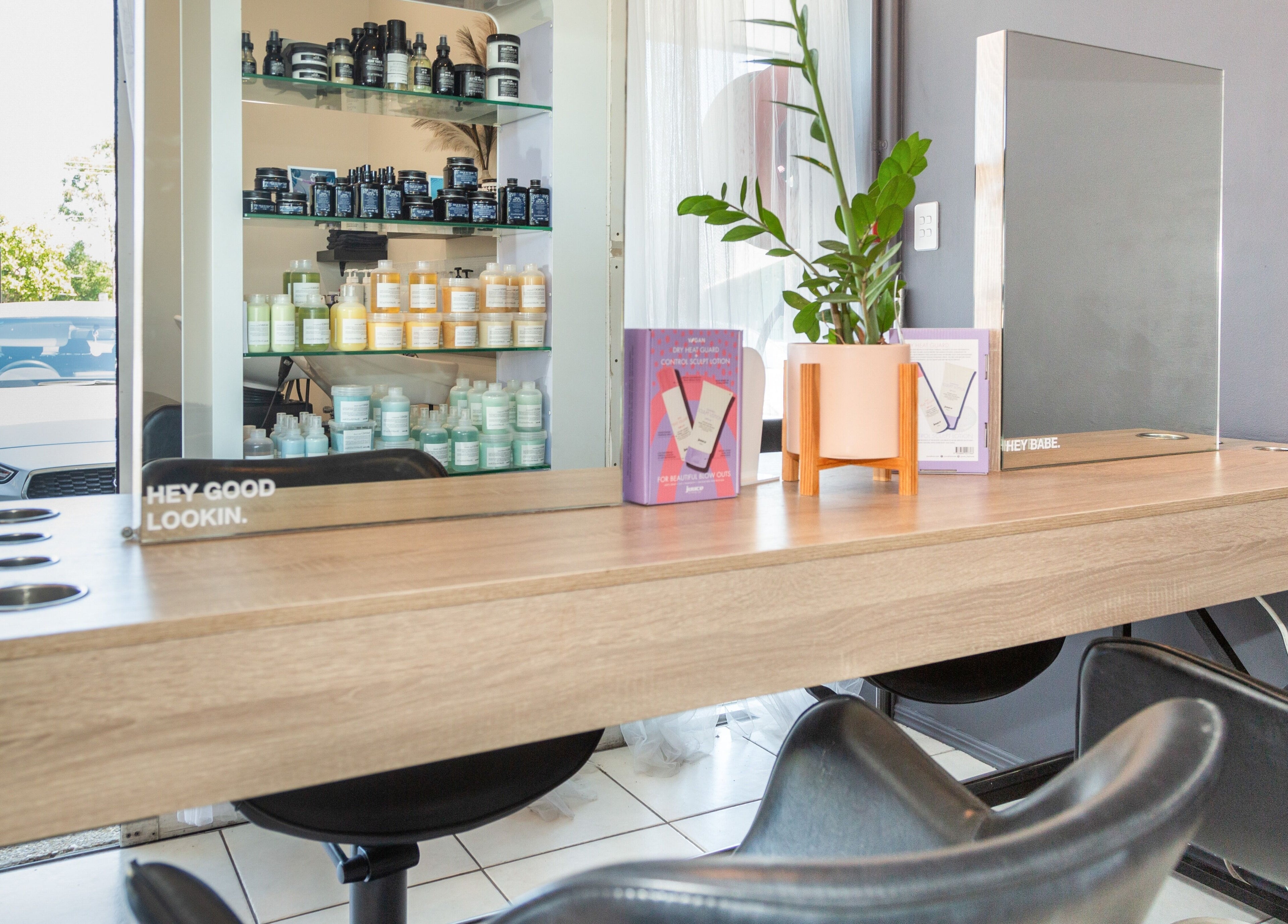 Modern styling station at The Hair Collective - Aesthetics Co., Helensvale, Queensland, AU with products displayed.