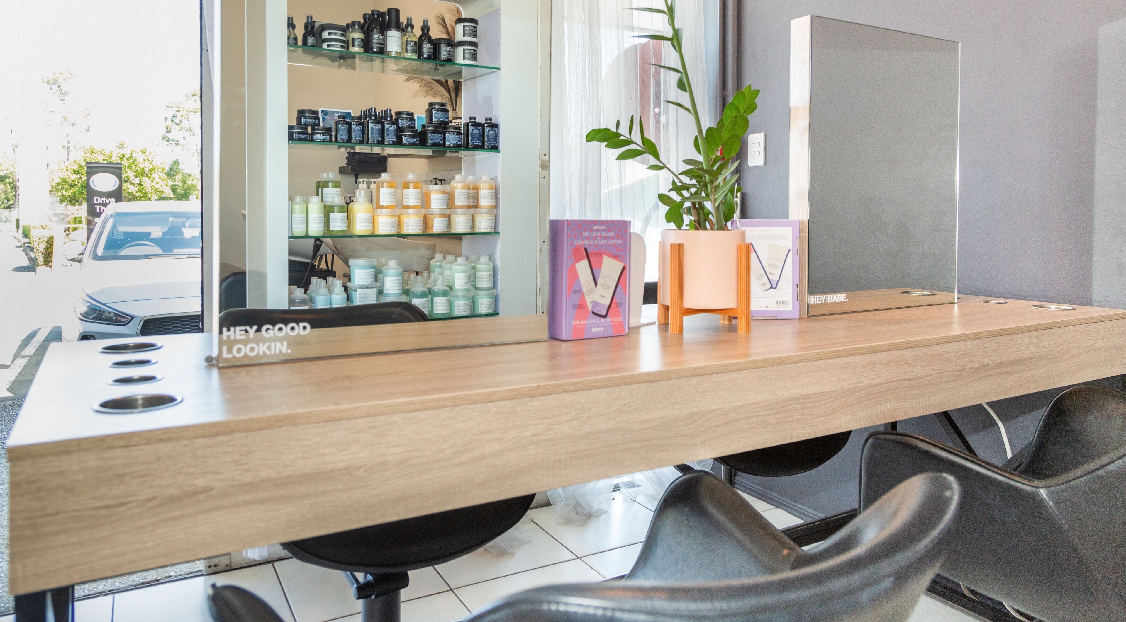 Modern styling station at The Hair Collective - Aesthetics Co., Helensvale, Queensland, AU with products displayed.