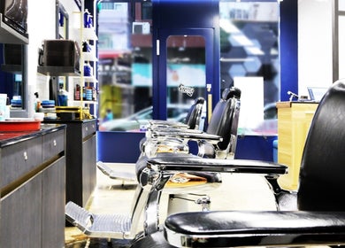 Interior of Dudes Barbershop in Sheung Wan, Hong Kong Island with stylish chairs and grooming products.