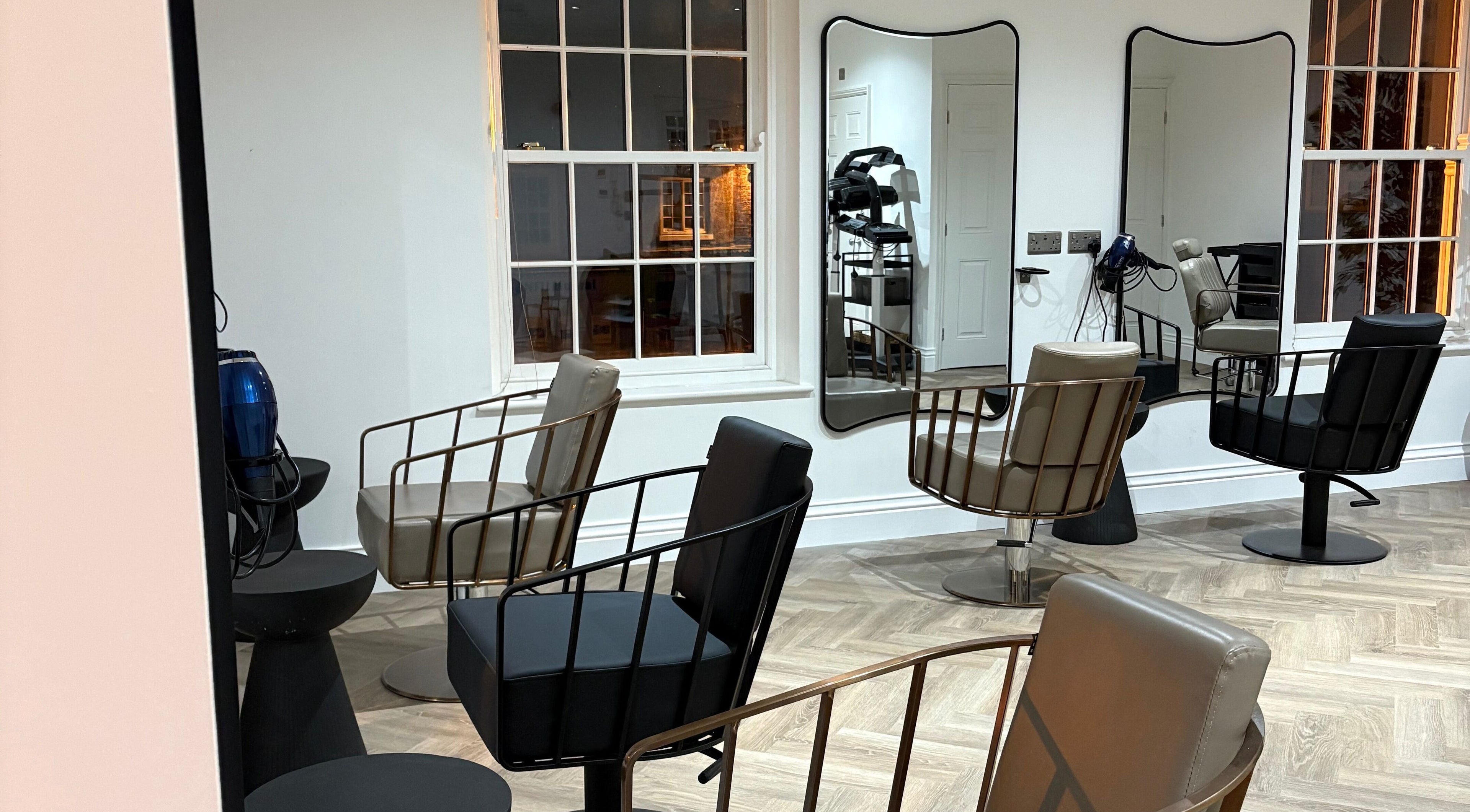 Modern salon interior at Hailgate Hair&Beauty in Howden, England, GB with stylish chairs and large mirrors.