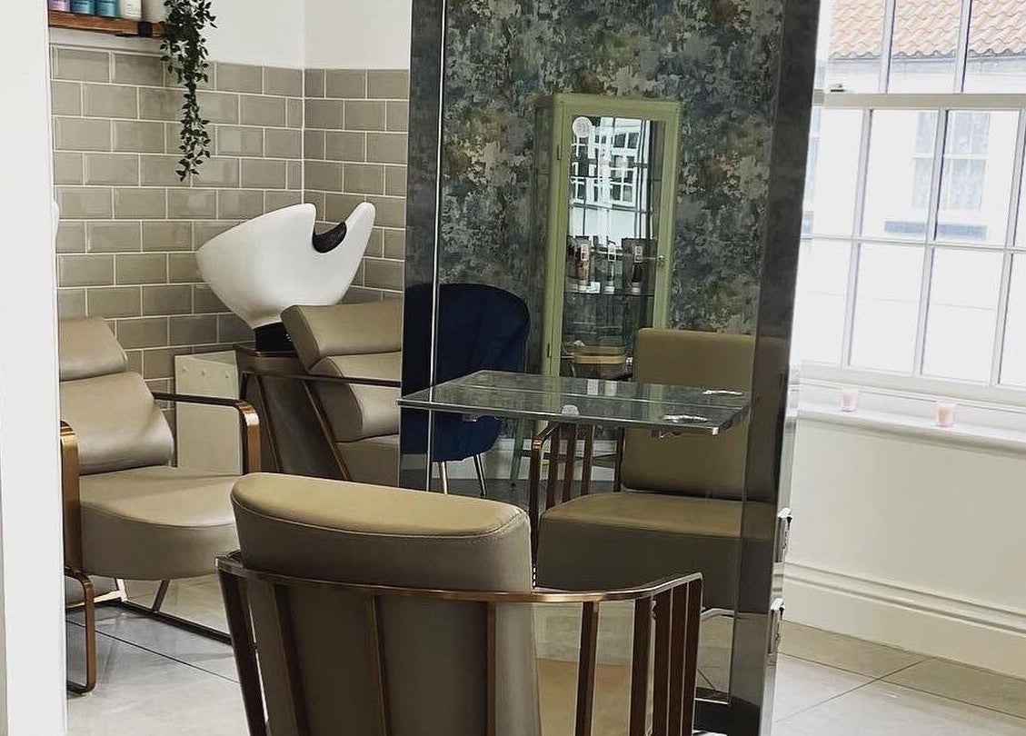 Chic salon interior at Hailgate Hair&Beauty, Howden, England, GB with modern chairs and window lighting.