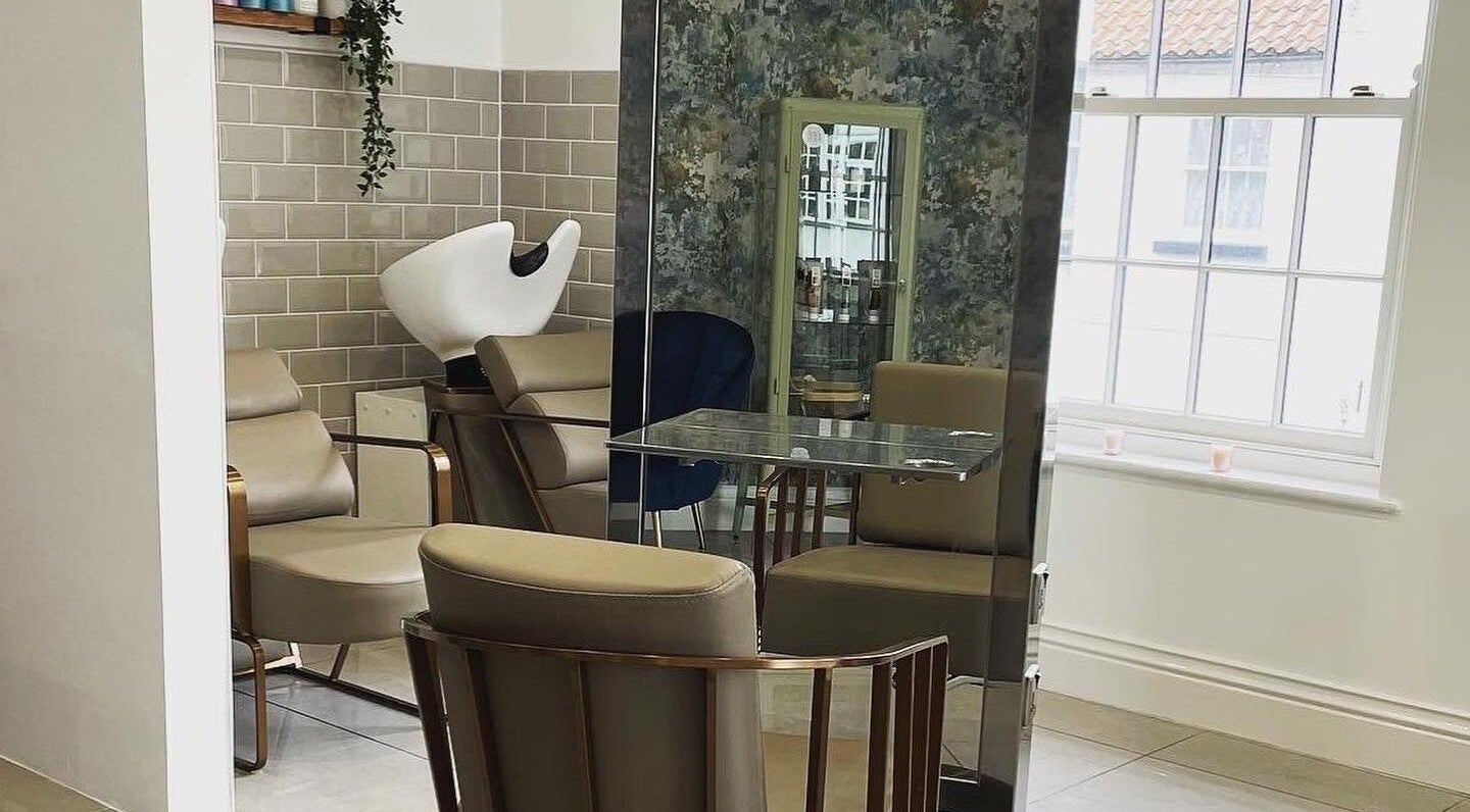 Chic salon interior at Hailgate Hair&Beauty, Howden, England, GB with modern chairs and window lighting.