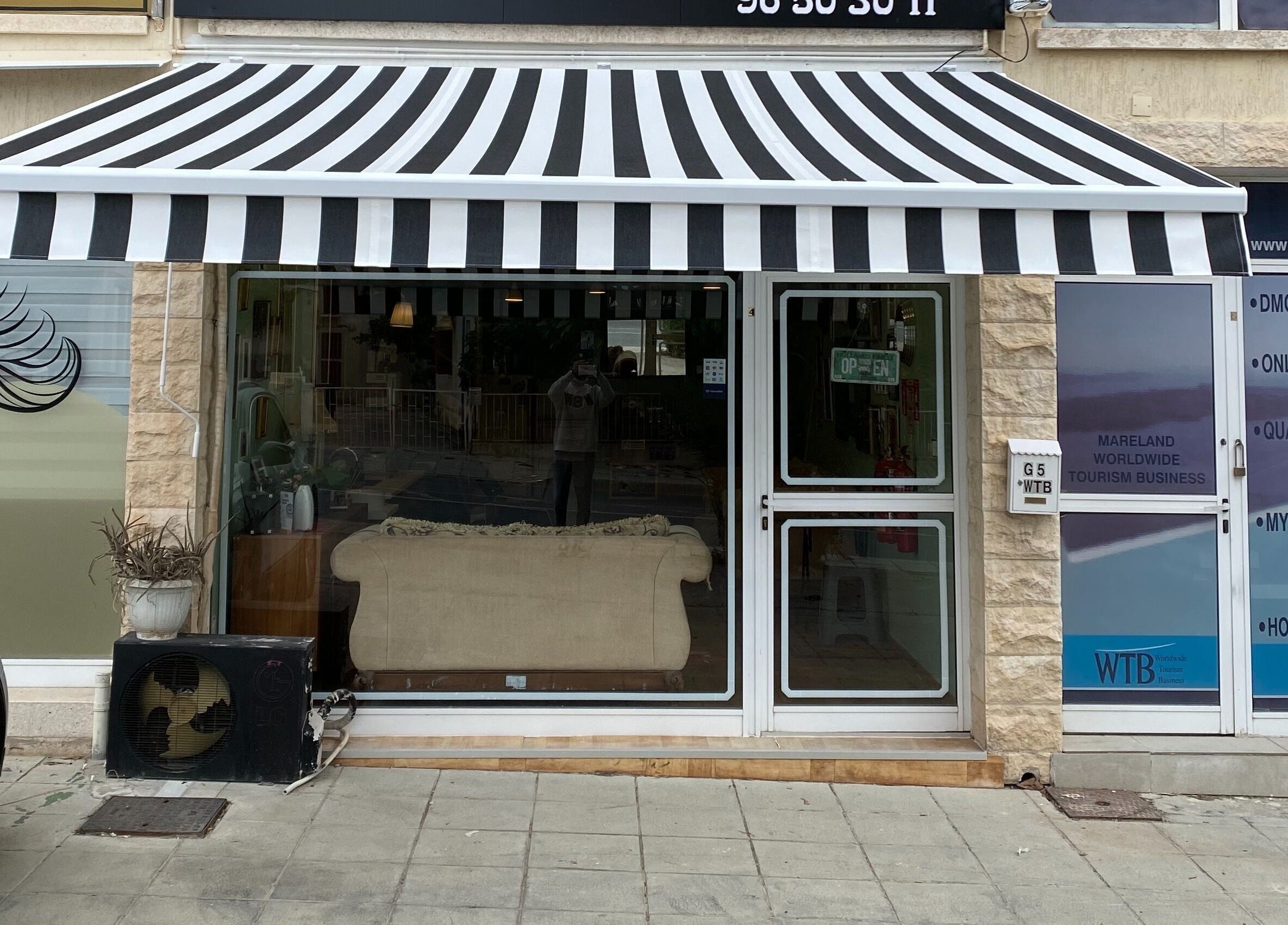 Front facade of Antonio Barbero in Mesa Geitonia, Limassol, CY, featuring a stylish striped awning.