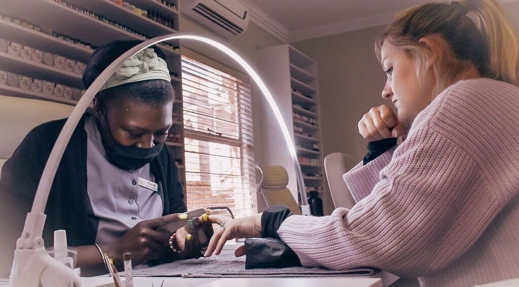 Nail artist at Beleza Wellness in Benoni, Gauteng, ZA providing professional manicure services.