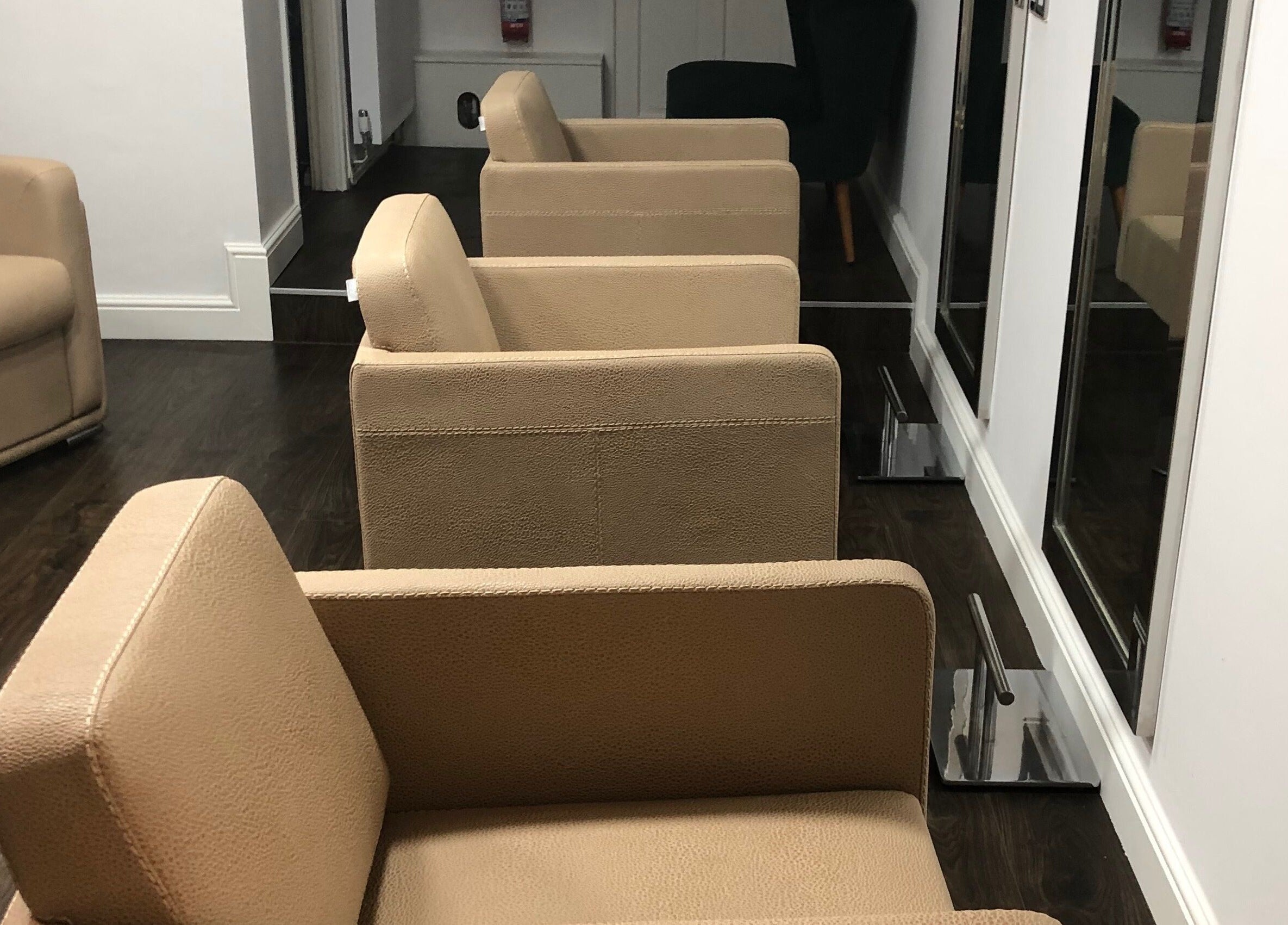 Modern salon chairs at The Salon Holt located in Holt, Wales, GB, offering a stylish and relaxing atmosphere.