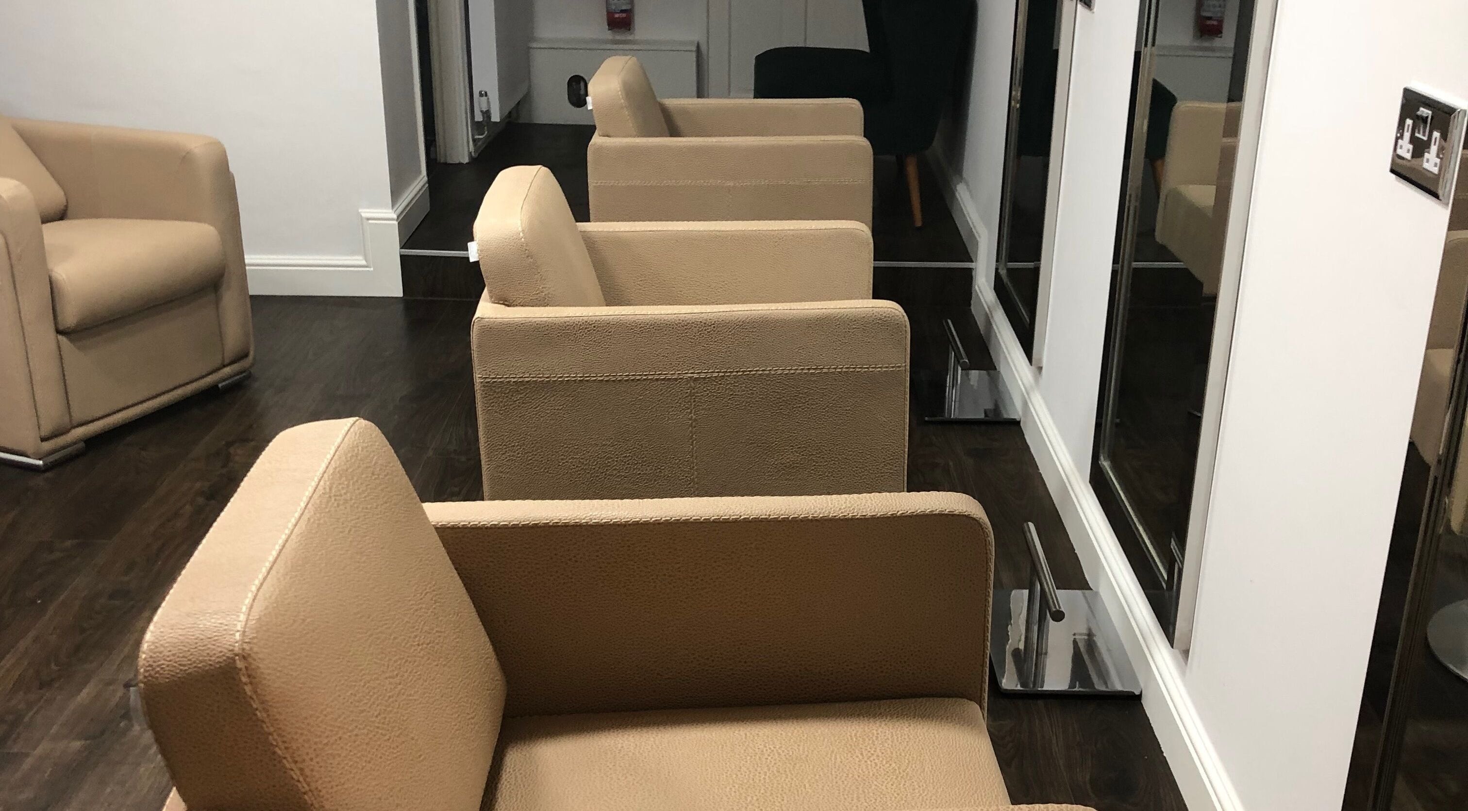 Modern salon chairs at The Salon Holt located in Holt, Wales, GB, offering a stylish and relaxing atmosphere.