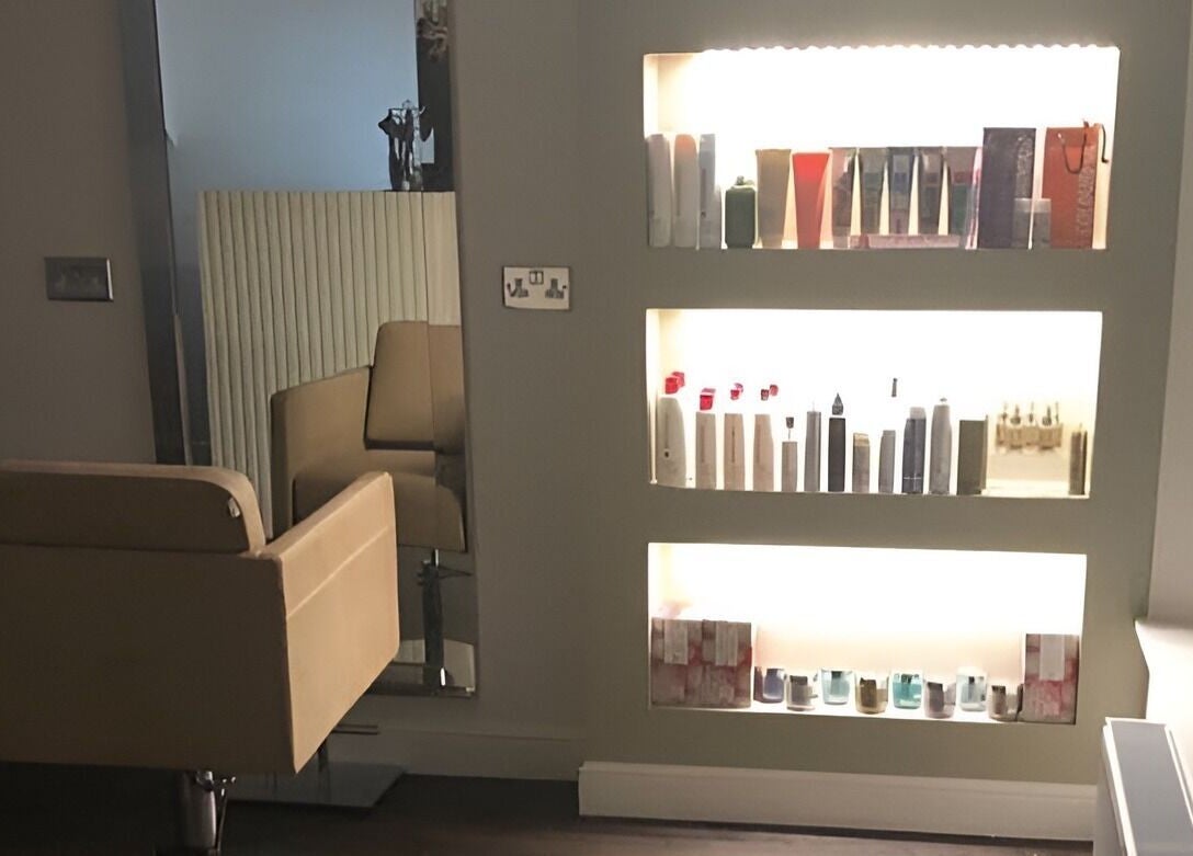 Elegant salon chair and product shelf at The Salon Holt, Holt, Wales, GB inviting relaxation and style.