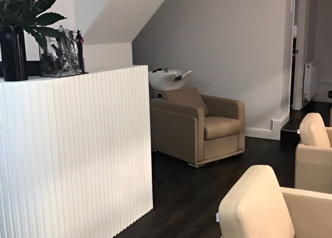 Elegant reception area at The Salon Holt, Holt, Wales, GB. Modern seating and decor create a serene atmosphere.