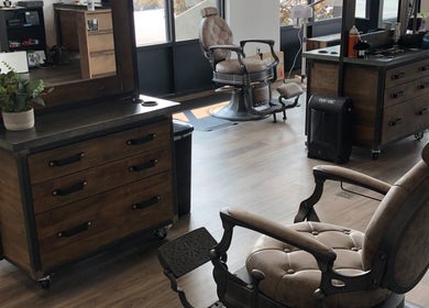 Interior view of Angie’s Barbershop in Billings, Montana, US, featuring stylish barber chairs and wooden decor.