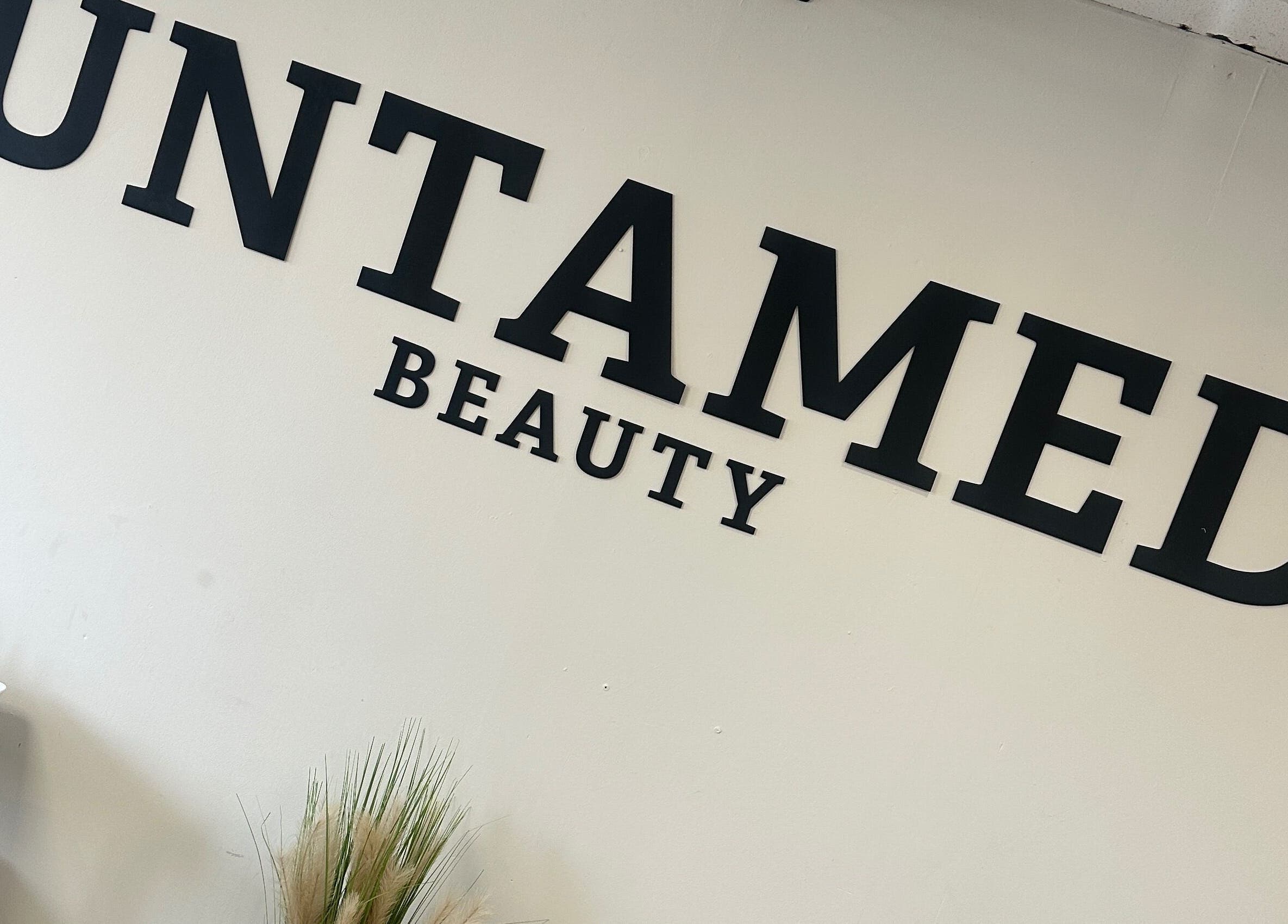 Untamed Beauty by Kelly wall sign at wellness venue in Consett, England, GB.