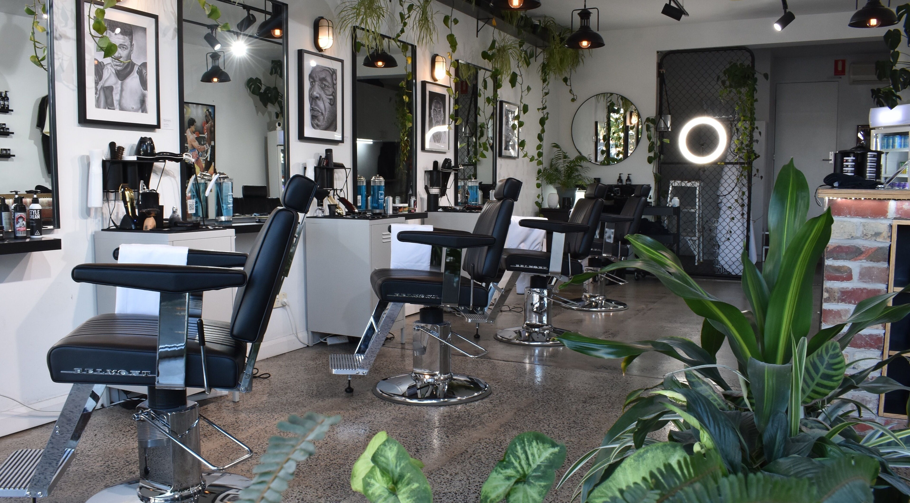 Interior of The Art Barbers St Kilda in Melbourne, Victoria, AU showcasing modern barber chairs and decor.