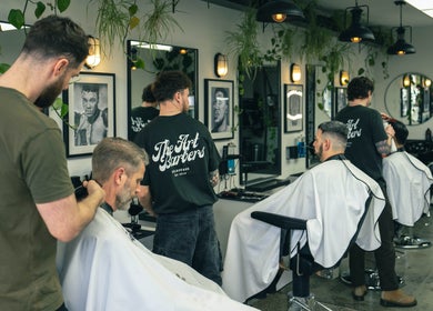 Stylish interior of The Art Barbers St Kilda with barbers at work, Melbourne, Victoria, AU.