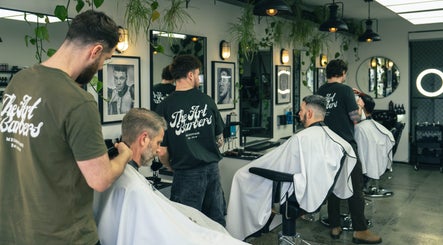 Stylish interior of The Art Barbers St Kilda with barbers at work, Melbourne, Victoria, AU.