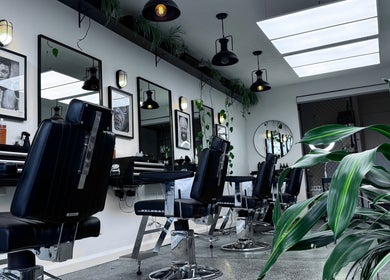 Stylish interior of The Art Barbers St Kilda in Melbourne, Victoria, AU showcasing sleek barber chairs and decor.