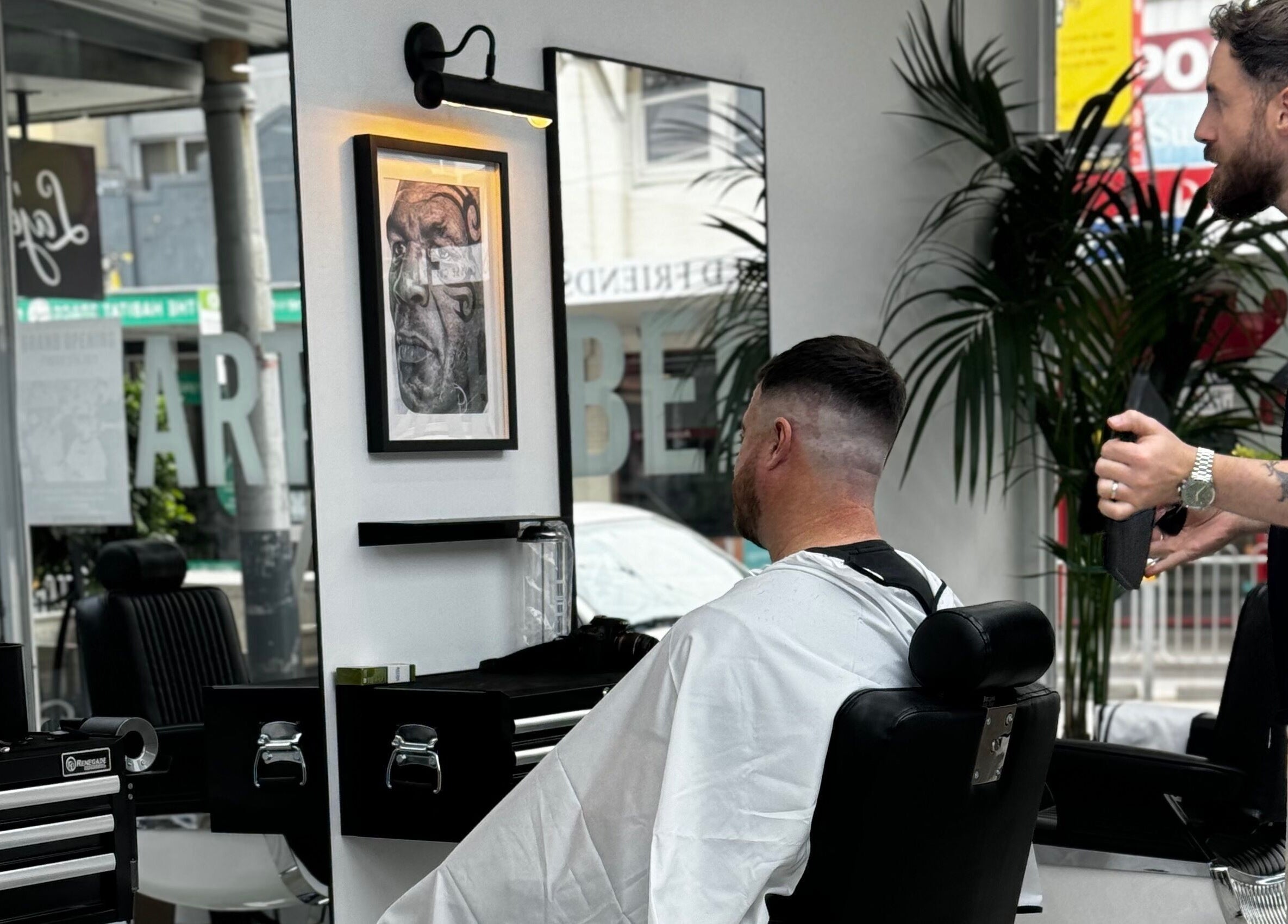 The Art Barbers Malvern stylist expertly trimming a client's hair in Melbourne, Victoria, AU.