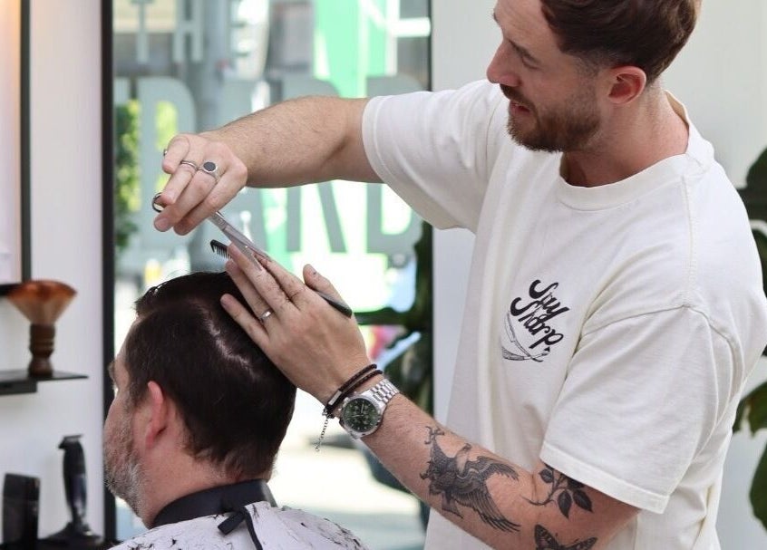 Barber at The Art Barbers Malvern styling a client's hair in Melbourne, Victoria, AU.