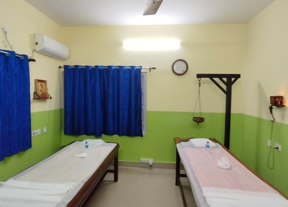 Therapy room at Arogya Ayurveda Panchakarma Center Pvt. Ltd., Kolkata, West Bengal, featuring massage beds and soothing decor.