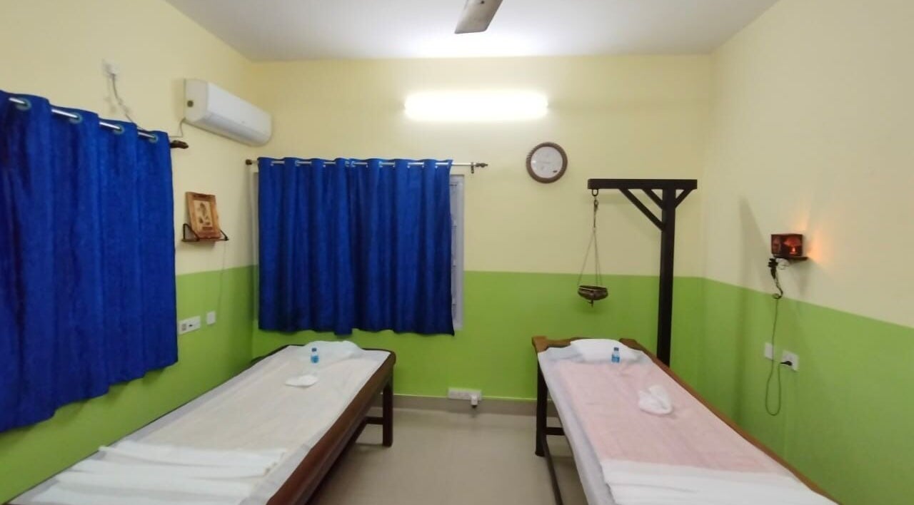 Therapy room at Arogya Ayurveda Panchakarma Center Pvt. Ltd., Kolkata, West Bengal, featuring massage beds and soothing decor.