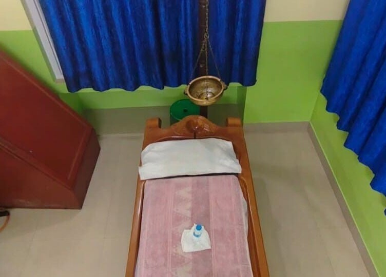 Massage therapy room at Arogya Ayurveda Panchakarma Center Pvt. Ltd., Kolkata, West Bengal, IN with traditional decor.