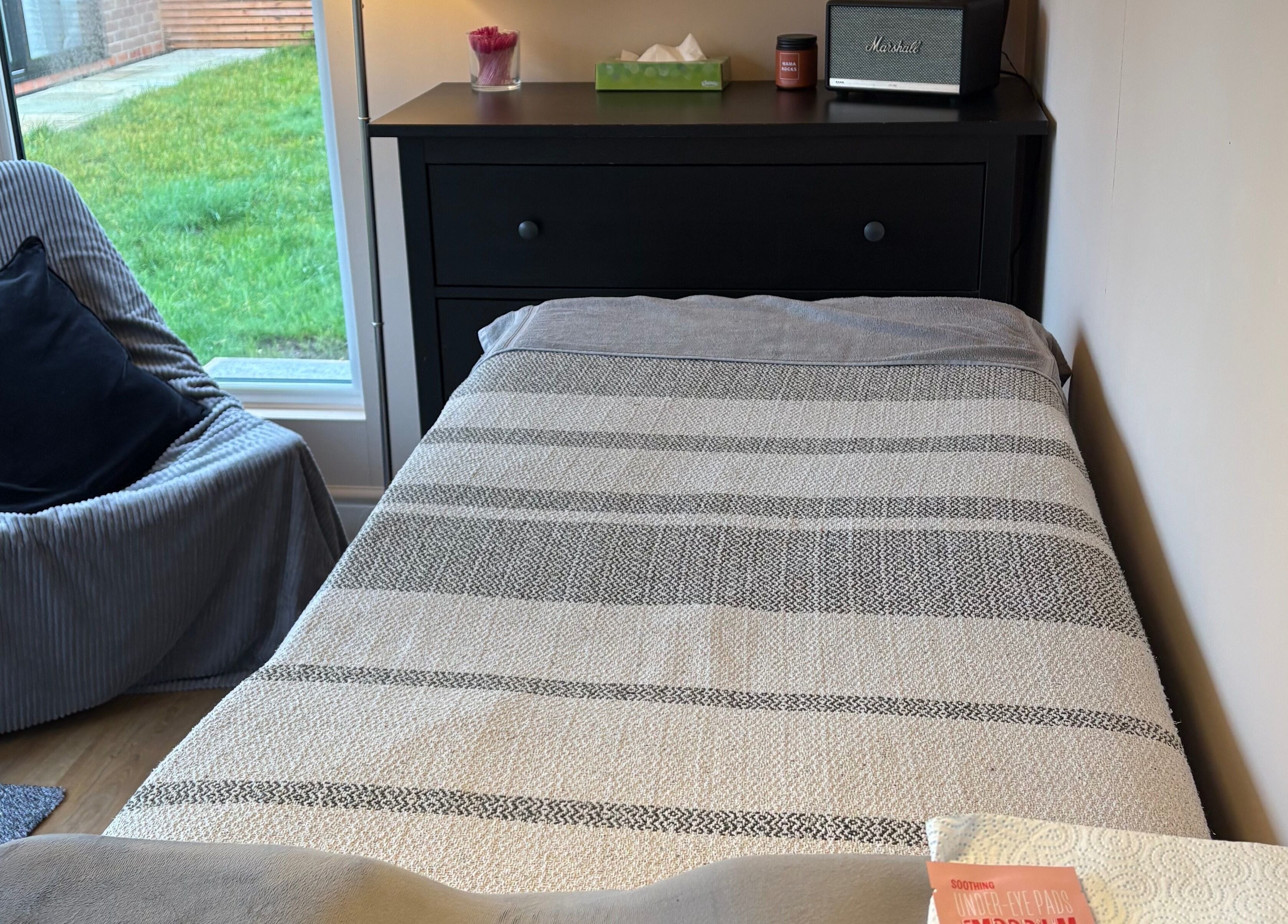 Relaxing treatment room at Zoe Hobley Beauty, Northwich, England, GB with cozy decor and comfortable bed.