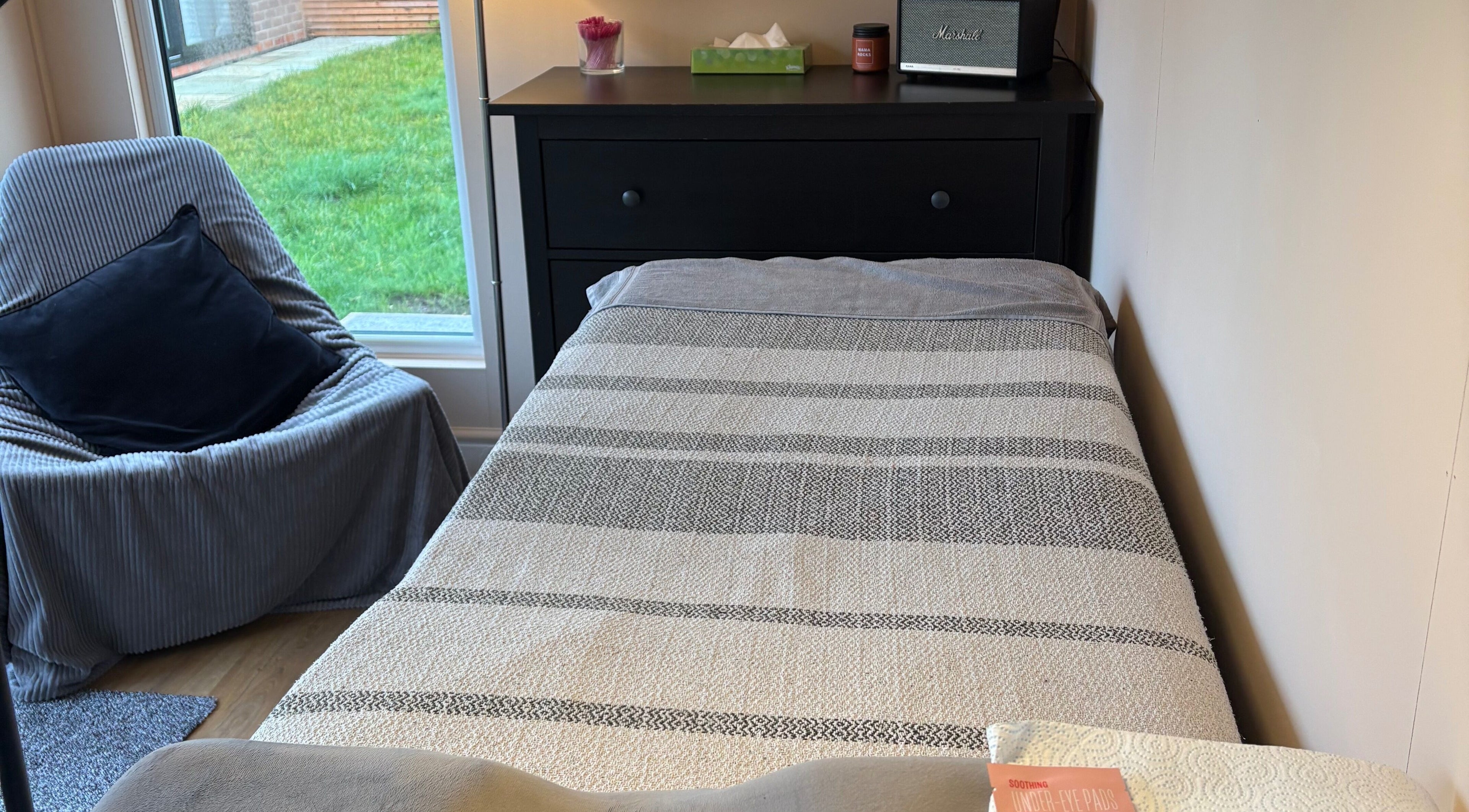 Relaxing treatment room at Zoe Hobley Beauty, Northwich, England, GB with cozy decor and comfortable bed.