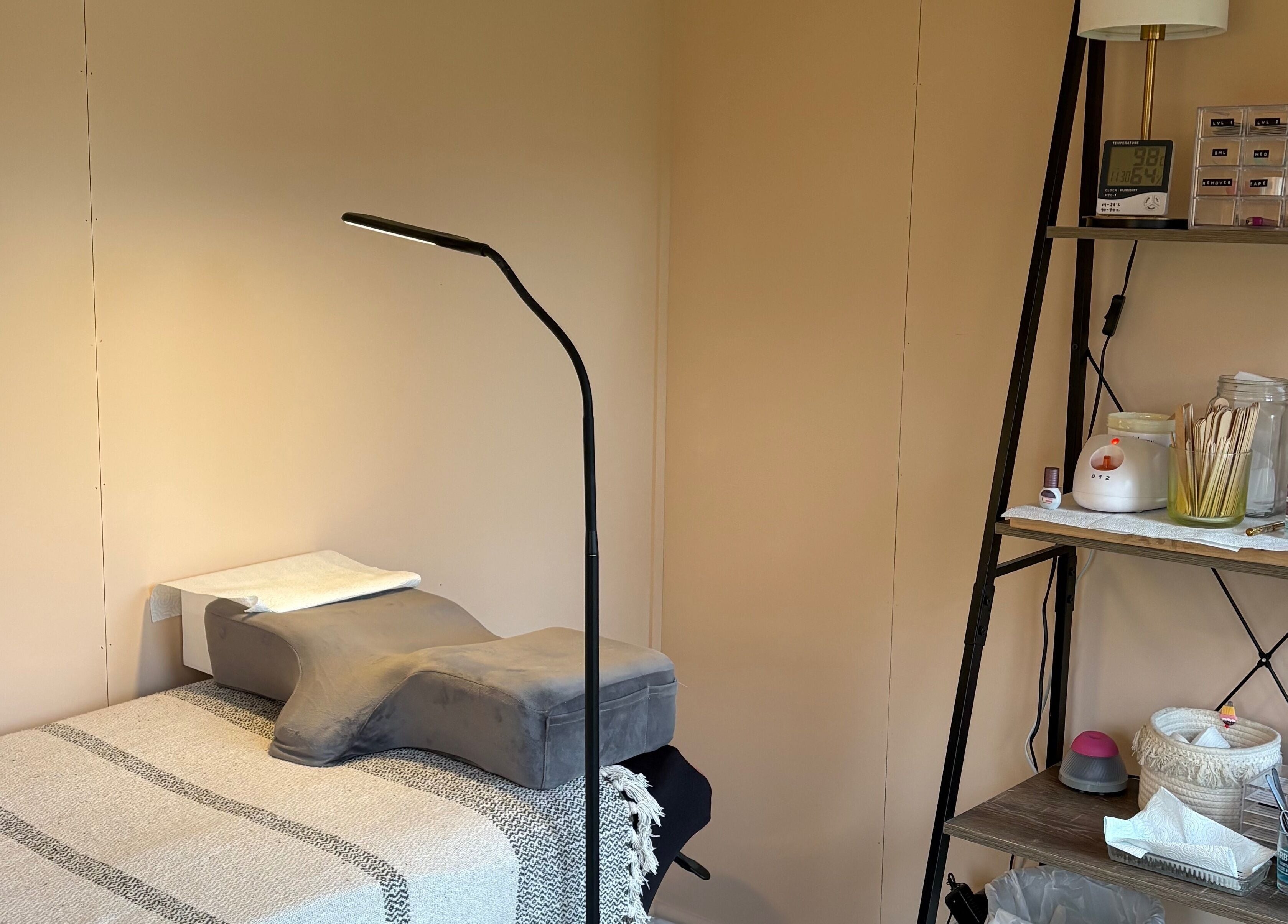 Calm treatment area at Zoe Hobley Beauty in Northwich, England, GB, showcasing a cozy massage table and supplies.
