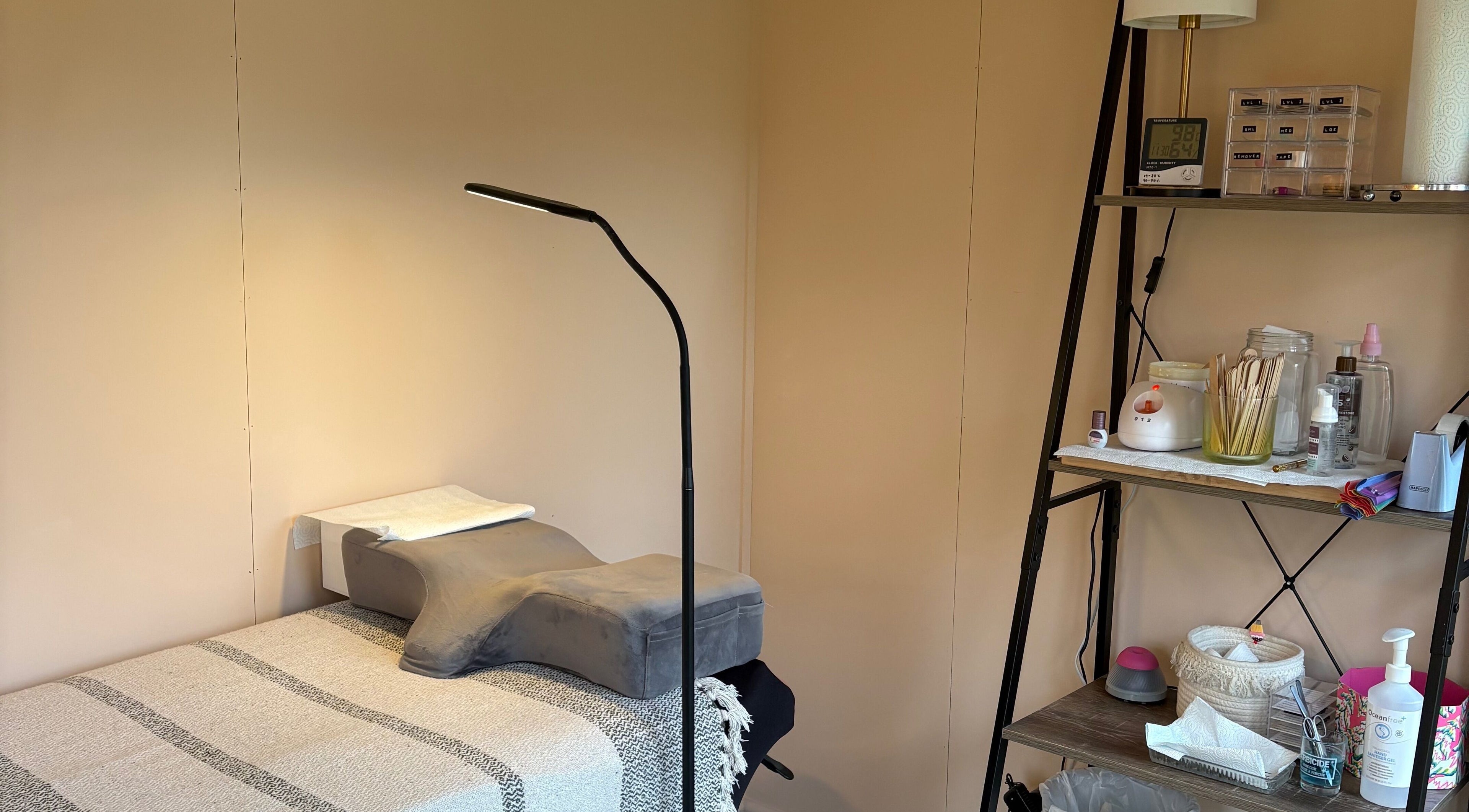 Calm treatment area at Zoe Hobley Beauty in Northwich, England, GB, showcasing a cozy massage table and supplies.
