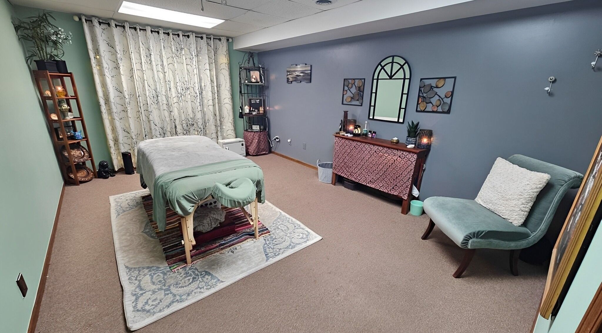 Tranquil massage room at Take Ten Massage in Waterford Township, Michigan, US with calming decor.