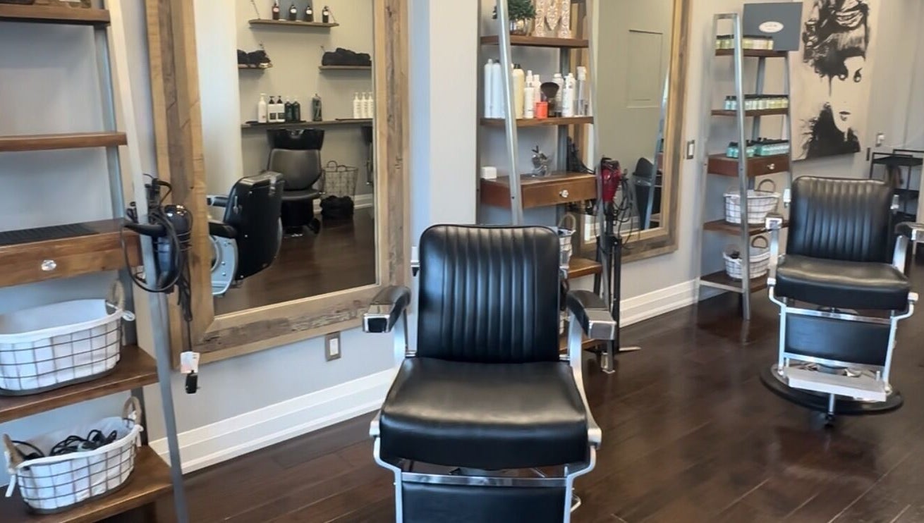 Inside M&Co. Hair Studio in Milton, Ontario, CA, featuring stylish black salon chairs and modern decor.