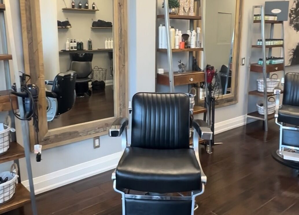 Inside M&Co. Hair Studio in Milton, Ontario, CA, featuring stylish black salon chairs and modern decor.