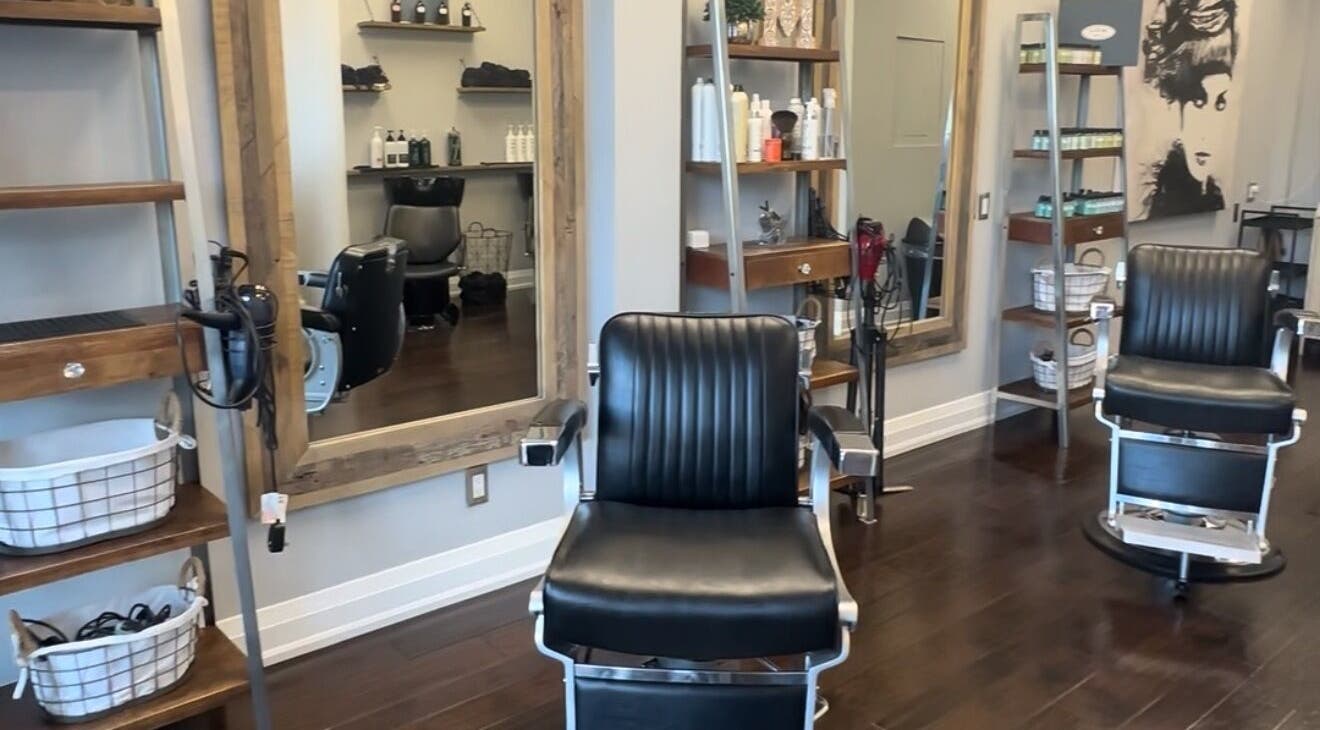 Inside M&Co. Hair Studio in Milton, Ontario, CA, featuring stylish black salon chairs and modern decor.