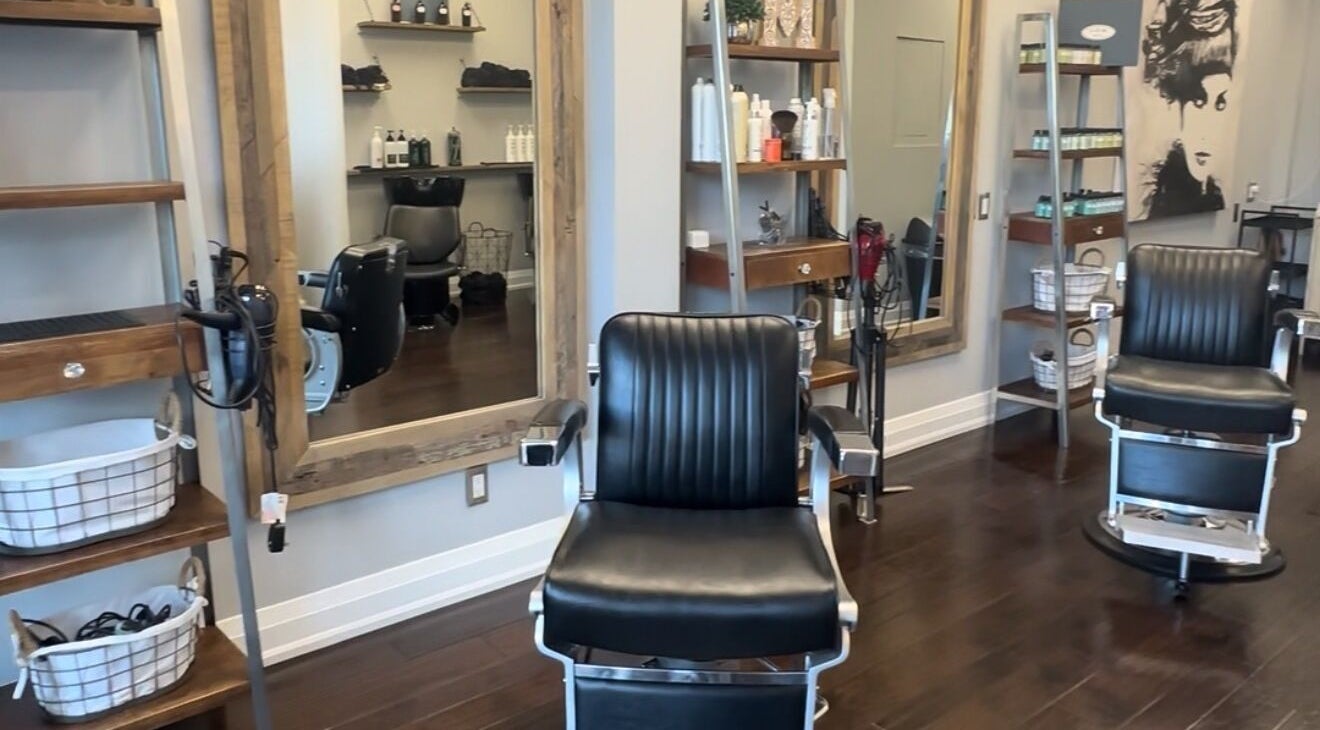 Inside M&Co. Hair Studio in Milton, Ontario, CA, featuring stylish black salon chairs and modern decor.