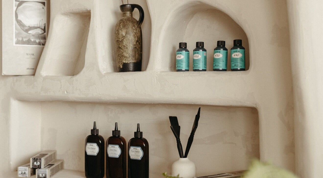 Stylish product shelves at M&Co. Hair Studio, Milton, Ontario, CA showcasing premium hair care items.