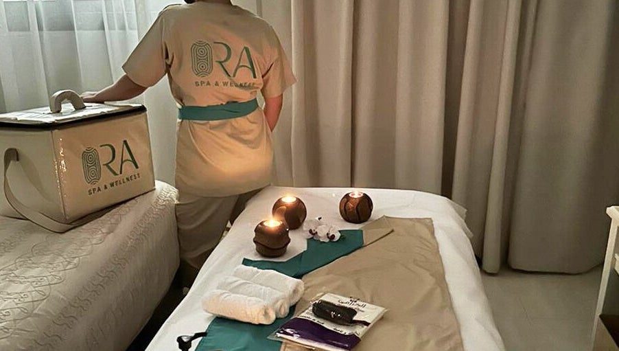 Relaxing spa setup at Ora Spa Home Service, Riyadh, Riyadh Province, SA with candles and towels.