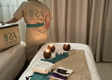 Relaxing spa setup at Ora Spa Home Service, Riyadh, Riyadh Province, SA with candles and towels.