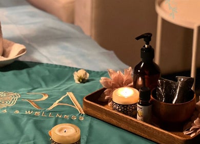 Ora Spa Home Service in Riyadh features a soothing setup with candles and wellness oils.